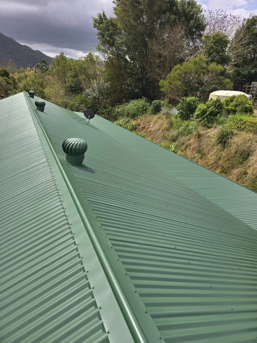 Metal roof painted green after restoration