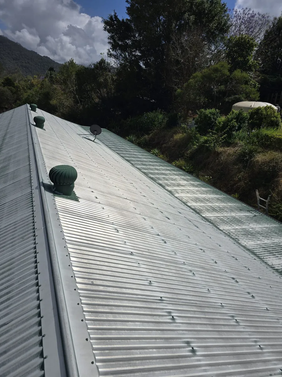 Faded silver metal roof before restoration